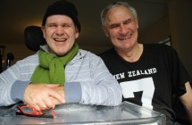 Two smiling men - a buddy in a wheelchair and his helper at the Drop In Centre