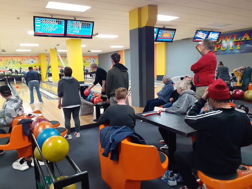 A group of people enjoying playing ten pin bowling