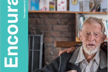 The front cover of The Encourager magazine featuring a photo of Hugh Willis