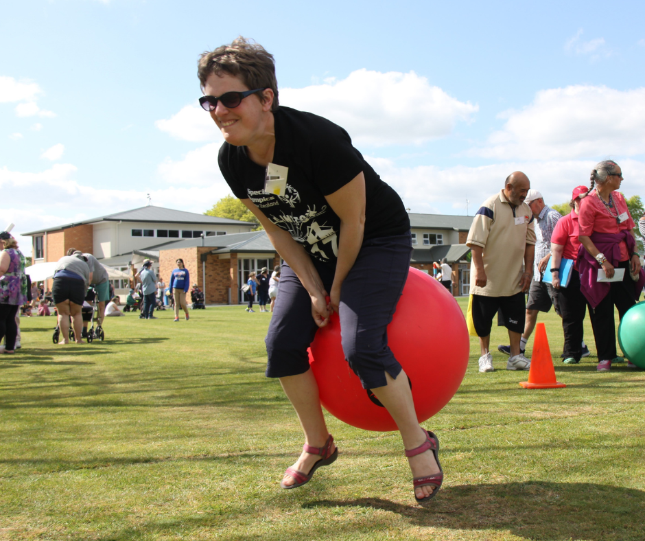 A lady takes part in a lively National Camp activity outside in the sun