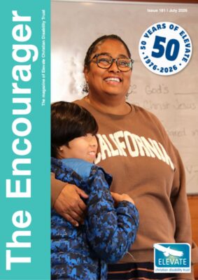 The Encourager magazine for July 2026 has the same teal blue strip on the left hand side of the cover reading the Encourager. The Elevate logo is in the bottom right hand corner. And a special circle denoting 50 years of Elevate sits in the top right hand corner. The image is of one leader and one young person sharing a side high during a programme at a camp for families with disabilities.