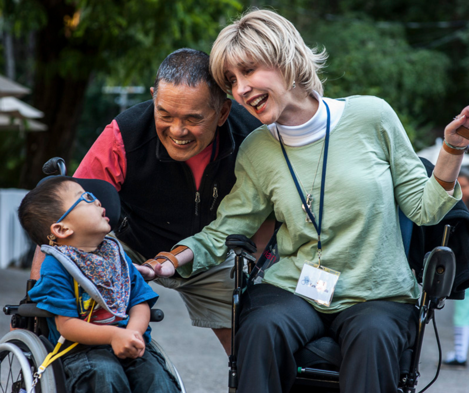Joni and Ken, founders of Joni and Friends are pictured outside with a young man their organisation supports