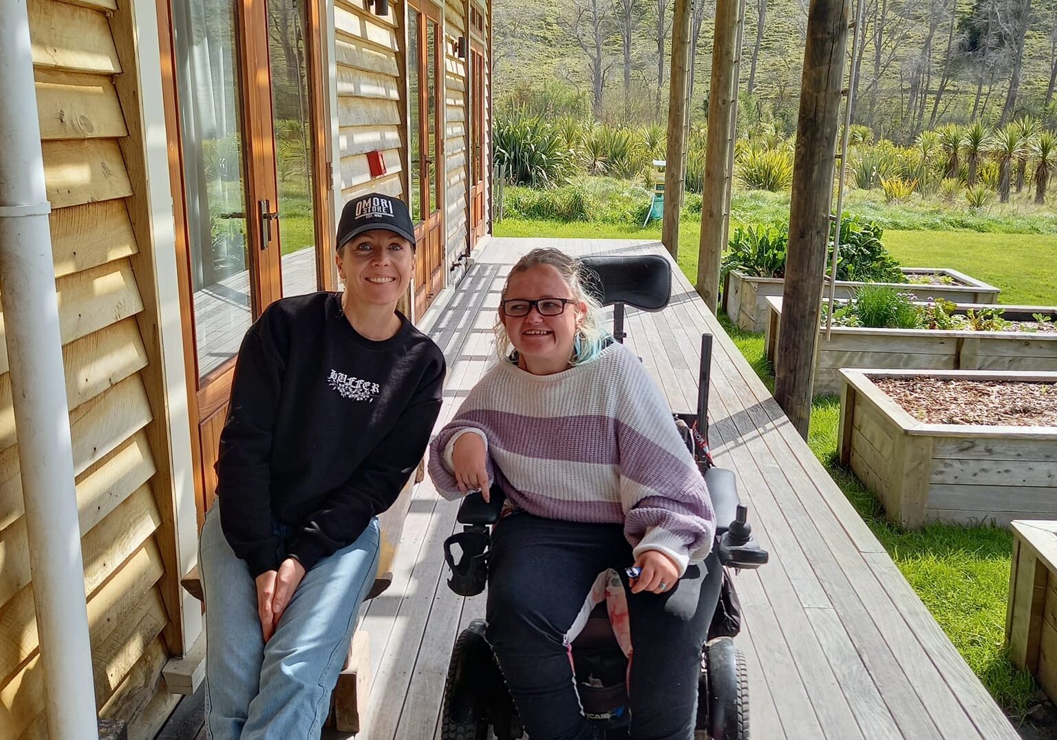 Two women sit together outside at a CFFD Hawkes Bay gathering