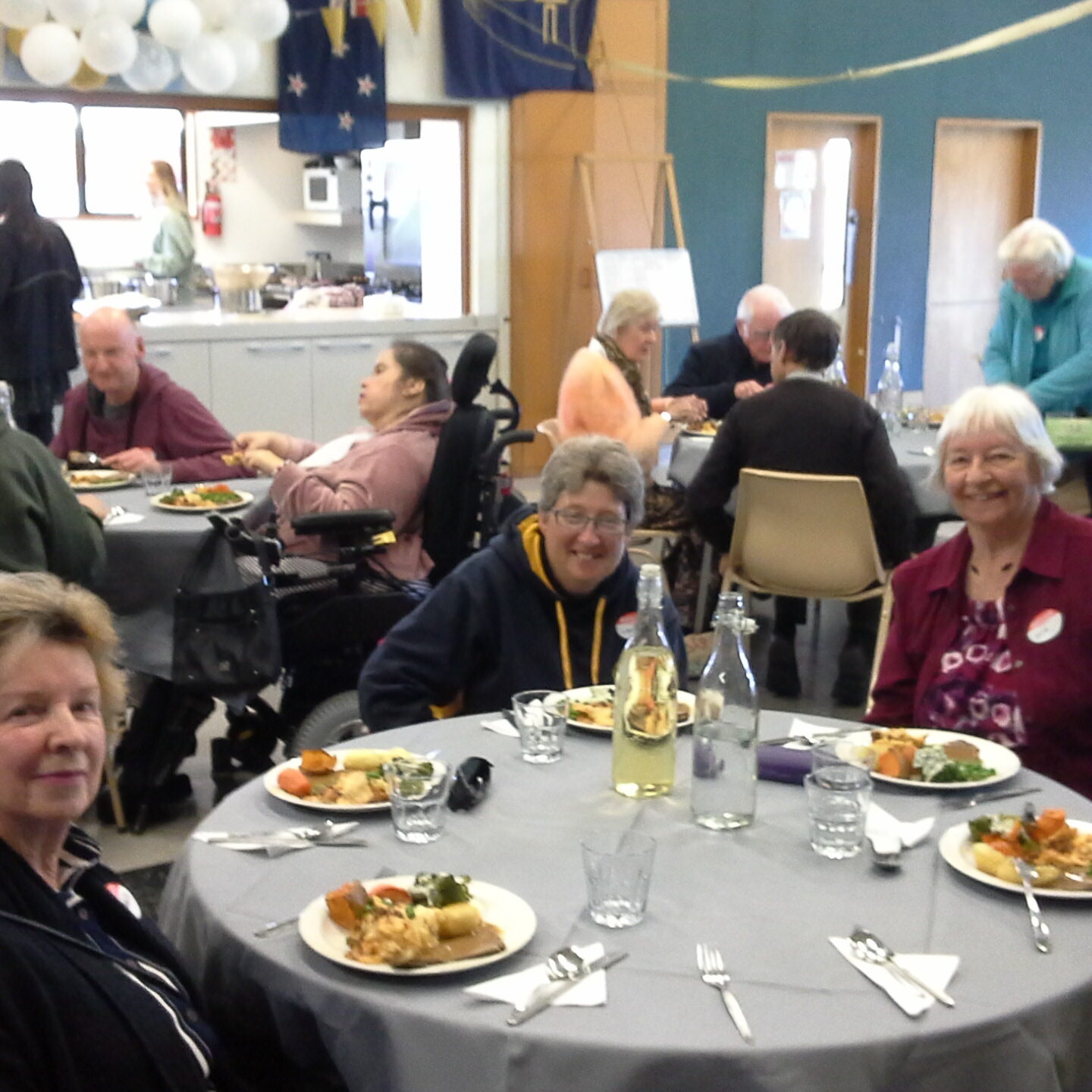 A group of people enjoying a meal together at a party celebrating CFFD Dunedin's 40th anniversary