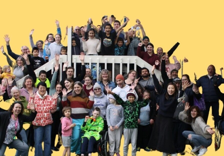 Large group photo of eight families at a Family Camp in 2022