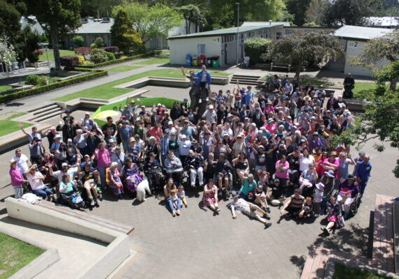 Large bird's eye view group photo of a few hundred people who attended a National Camp